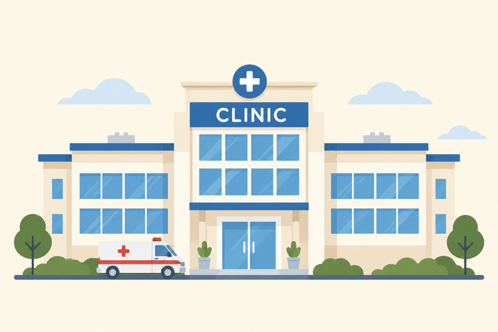 A clinic building illustration, with an ambulance parked outside the entrance